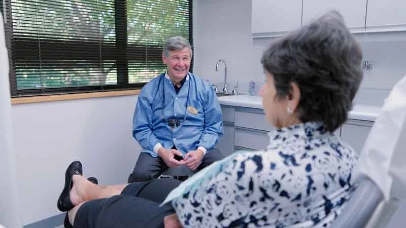 Dr. Alan Brodine of Brodine Prosthodontics talking with a patient