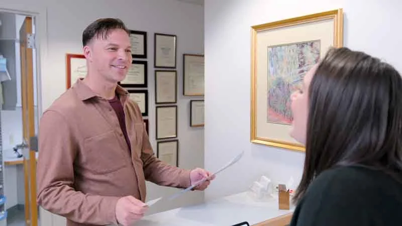 man checking out at Brodine Prosthodontics