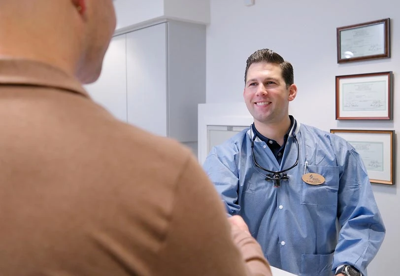 Dr. Brian Brodine discussing dental treatment with a patient
