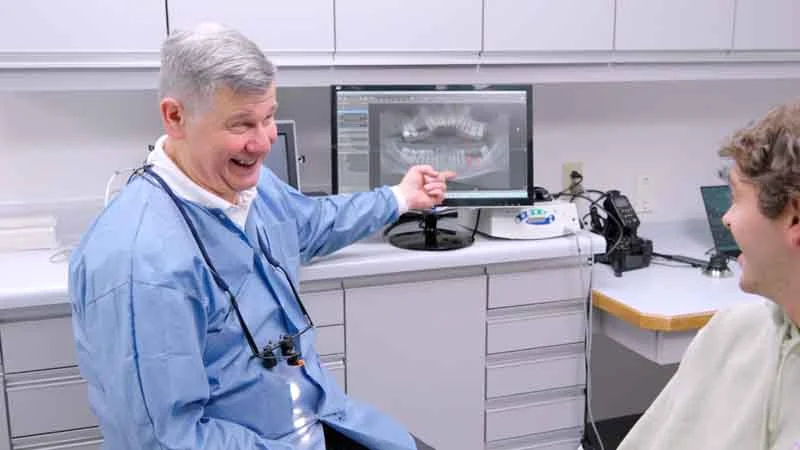 Dr. Alan Brodine showing a patient their dental X-rays